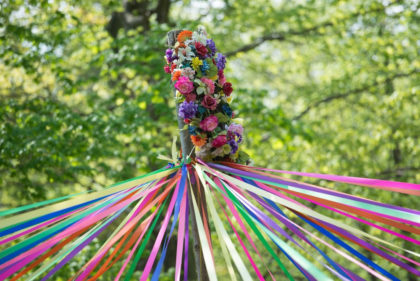 Colorful maypole with flowers